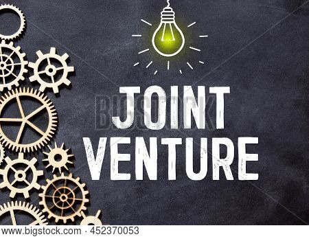 Business And Finance Concept. On A Brown Surface Lies A Pen, Crumpled Paper And A Notepad With The I