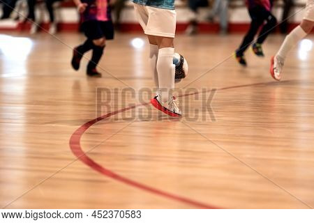 A Child Intercepts The Ball With Both Legs