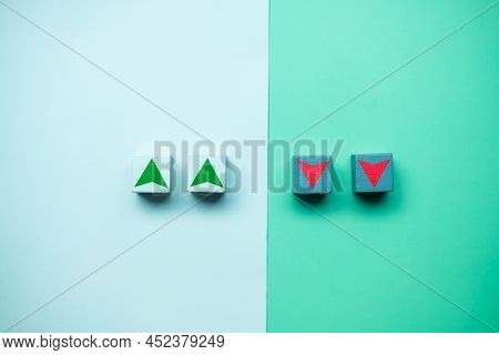 Wood Cube Block With Down And Up Arrows Icon. Conceptual Image Of Stock Market And Economy Down And 
