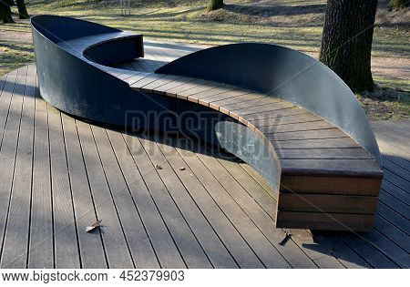 The S-shaped Bench Resembles A Snake And Is Made Entirely Of Small Wooden Planks Bolted To A Black S