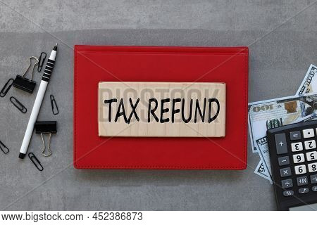 Tax Refund - Text On Wood Board On Red Notepad