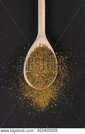 Khmeli-suneli In Wooden Spoon On Dark Background. Georgian Traditional Spices.