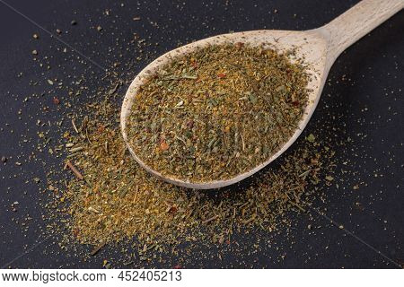 Close Up Image Of Khmeli-suneli In Wooden Spoon. Georgian Traditional Spices.