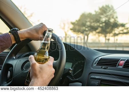 Man Drinking Alcohol While Driving In His Car.