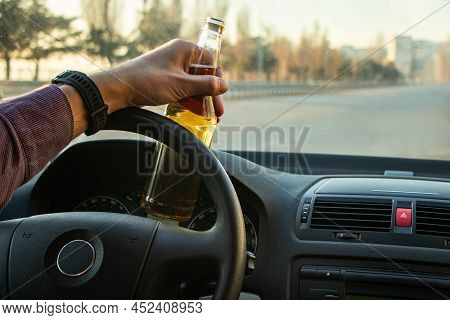 Man Drinking Alcohol While Driving In His Car.