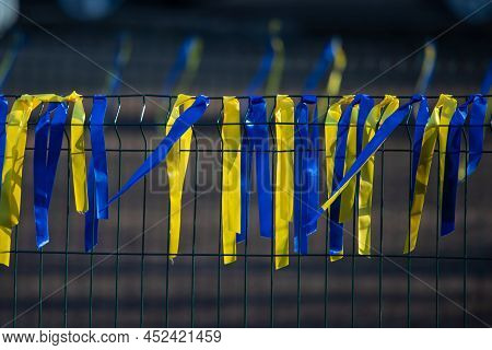 Ribbons On The Fence, Symbols Of Ukraine. Blue And Yellw Are The Colors Of Ukrainian National Flag. 
