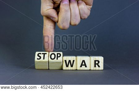 Stop War Symbol. Businessman Turns Cubes And Changes Concept Words War To Stop War. Beautiful Grey T