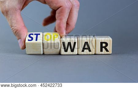 Stop War Symbol. Businessman Turns Cubes And Changes Concept Words War To Stop War. Beautiful Grey T