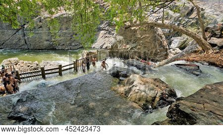 Hogenakkal,tamilnadu,india-march 19 2022: Tourists Taking Bath In Hogenakkal Falls. Hogenakkal Falls