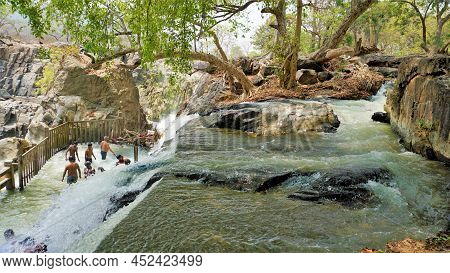 Hogenakkal,tamilnadu,india-march 19 2022: Tourists Taking Bath In Hogenakkal Falls. Hogenakkal Falls