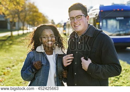 Couple Of Students At The University Having Good Time Close To The Bus Station