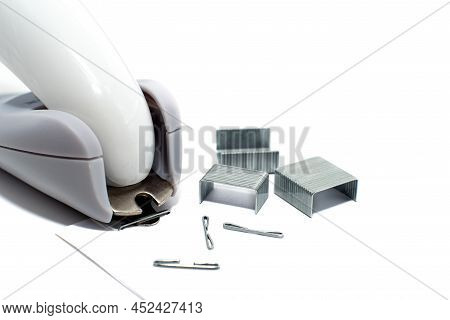 Anti-stapler With Clerical Staples On A White Background. Stationery. Stapler