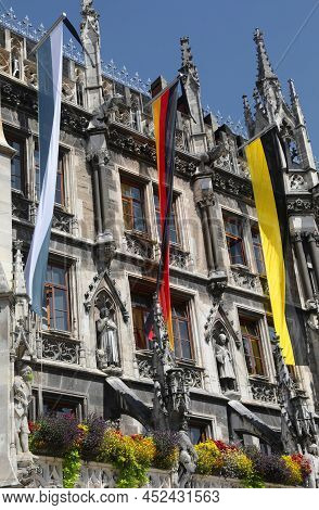 Munich City Hall In Germany With Three Big Flags Of The Nation Of The City And Of Bavaria Region