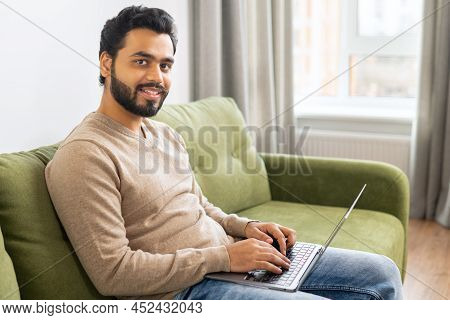 Young Indian Male Student Watching Webinars, Educational Courses, Learning On The Distance. Front Vi