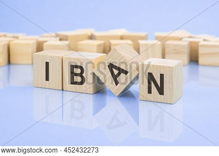 Wooden Cubes With The Letters Iban On The Bright Surface Of A Pale Lilac Table. Iban - Short For Int