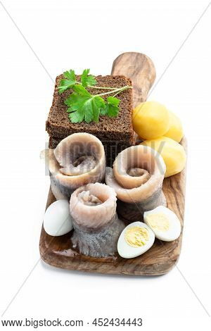 Homemade  Marinated Herring Roll With Rye Bread And Baby Potato With Quial Eggs Isolated In White