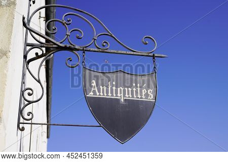 Store Facade Wall Panel In The Street With Retro Text Antiques In French Antiquites Traduction Means