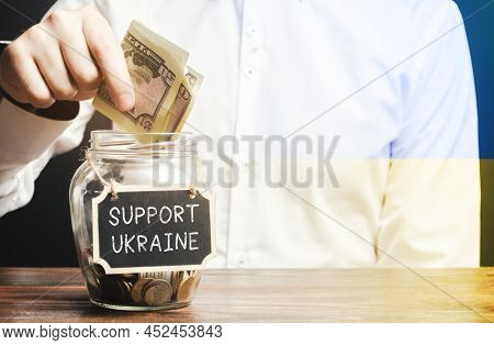A Man Donates Money To Support Ukraine. Financial Assistance To Ukrainian Refugees Who Suffered From