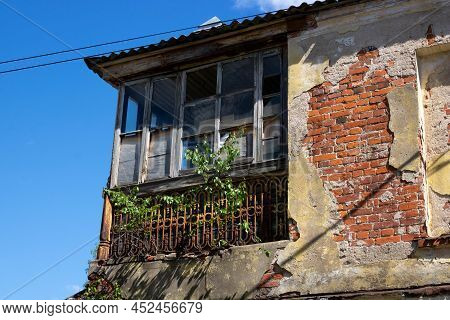The Old Balcony Is A Shabby Rough, Cracked Wall. The Concept Of Devastation Caused By War, Poverty.