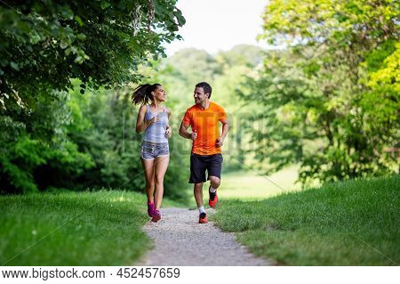 Portrait Of Happy Fit People Running Together Ourdoors. Couple Sport Healthy Lifetsyle Concept