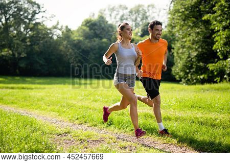 Portrait Of Happy Fit People Running Together Ourdoors. Couple Sport Healthy Lifetsyle Concept