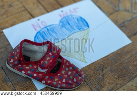Childrens Shoes And The Flag Of Ukraine, The Warthe War In Ukraine.