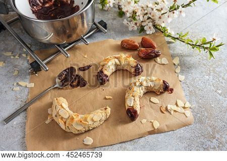 Baking Healthy Almond Crescent Cookies From Almonds, Oat Flakes And Dates With Dark Chocolate, Rusti