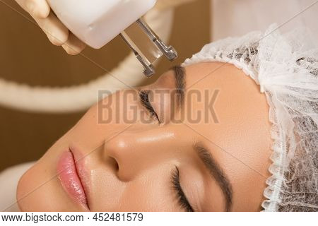 Beautiful Woman In Beauty Salon During Rejuvenation Procedure