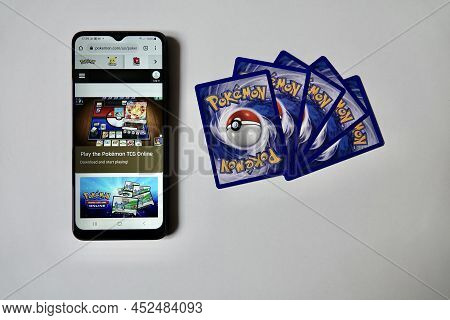 Prague, Czech Republic - April 3 2022:. Back Side Of Pokemon Cards And Smartphone With Ptcg. The Pok