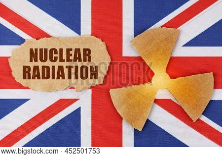 Industry And Radiation Concept. On The Flag Of Great Britain, There Is A Symbol Of Radioactivity And