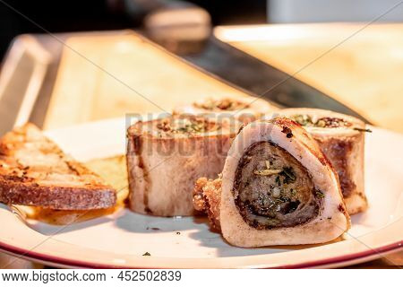 Baked Beef Bones With Bone Marrow Are On A Plate