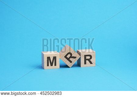 Wooden Cubes With Letters Mrr, Blue Background, Business Concept. Mrr - Short For Monthly Recurring 