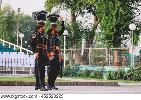 Wagah Border, Pakistan - July 22, 2021: Brave Pakistan Soldiers In Bright Military Uniform Marching 