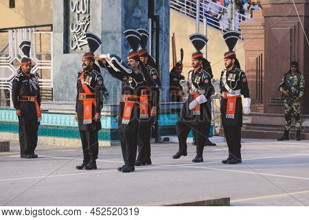 Wagah Border, Pakistan - July 22, 2021: Brave Pakistan Soldiers In Bright Military Uniform Marching 