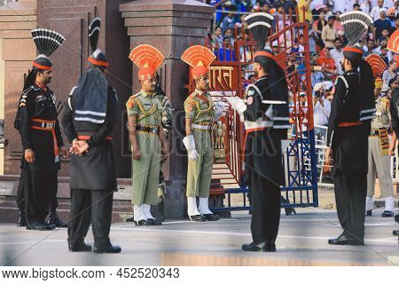 Wagah Border, Pakistan - July 22, 2021: Brave Pakistan Soldiers In Bright Military Uniform Marching 