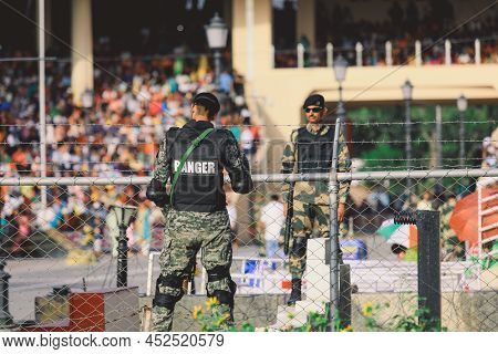 Wagah Border, Pakistan - July 21, 2022: Brave Pakistan Soldier In Sunglasses With The Gun Near The M