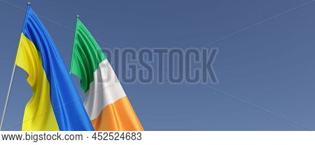 Flags Of Ireland And Ukraine On Flagpoles On Side. Flags On A Blue Background. Place For Text. Indep