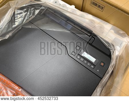 London, United Kingdom - Ap 3, 2022: Unboxing Cardboard Box Of A New Canon Pixma G550 Single Functio