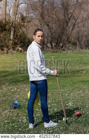 Man Looking At The Camera Devoted To The Community Picking Up Trash In The Park