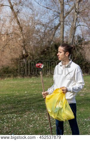 Young Man Proud To Help The Community By Picking Up Trash From Nature