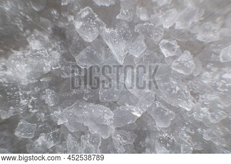 Coarse White Iodized Salt. Detailed Background Texture Macro Close-up. Salt Crystals Of Different Si