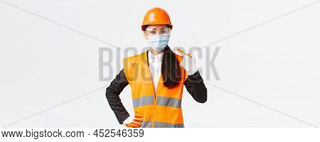 Covid-19 Safety Protocol At Enterpise, Construction And Preventing Virus Concept. Confident Asian Fe