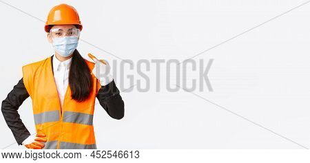 Covid-19 Safety Protocol At Enterpise, Construction And Preventing Virus Concept. Confident Asian Fe