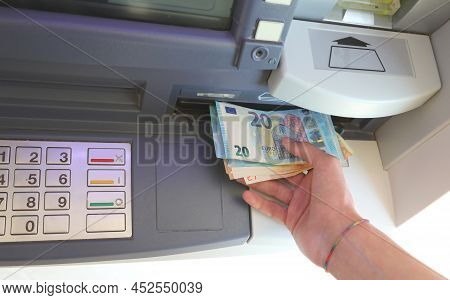 Automatic Atm And Banknotes In Euro And The Hand