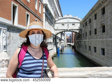 Pretty Young Woman With Mask During Lockdown In Venice In Italy And The Brdige Of Sighs In Backgroun