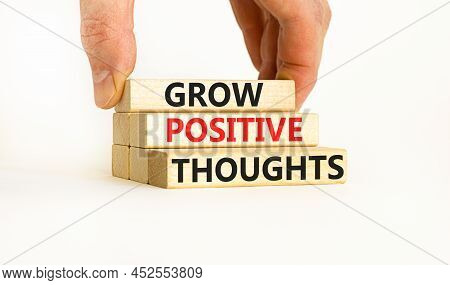 Grow Positive Thoughts Symbol. Concept Words Grow Positive Thoughts On Blocks. Businessman Hand. Bea