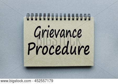 Grievance Procedure Text On A Gray Notepad On A Gray Background In Black Letters