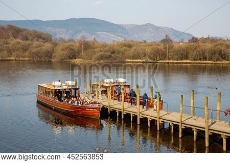 Derwent Water, Keswick, Uk - March 23, 2022.  Tourists Boarding A Tour Boat On Derwent Water In The 