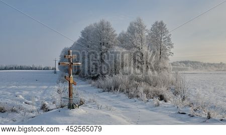 Winter Landscape With Tree Snow Wrapped Against Distant Forest Skyline With Orthodox Chyrch Wooden C