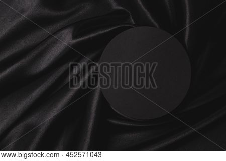 Empty Round Platform Podium On Beautiful Black Color Background With Drapery And Wavy Folds Of Silk 